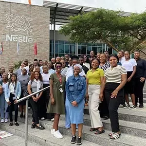 young people standing next to Nestle building 
